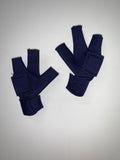Two dark blue fingerless gloves with Velcro straps, resembling a Birdy Bootie (Made in USA) used for bird's injured feet protection, are laid out on a plain white surface.