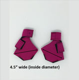 A pair of pink origami earrings, styled as Clearance Birdy Booties, with a wide inside diameter.