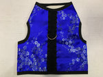 A blue and black Custom Boutique Kitty Holster Cat Harness with a floral pattern and comfortable fabric.
