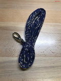 A blue and white Clearance Holster Leash on a wooden table.